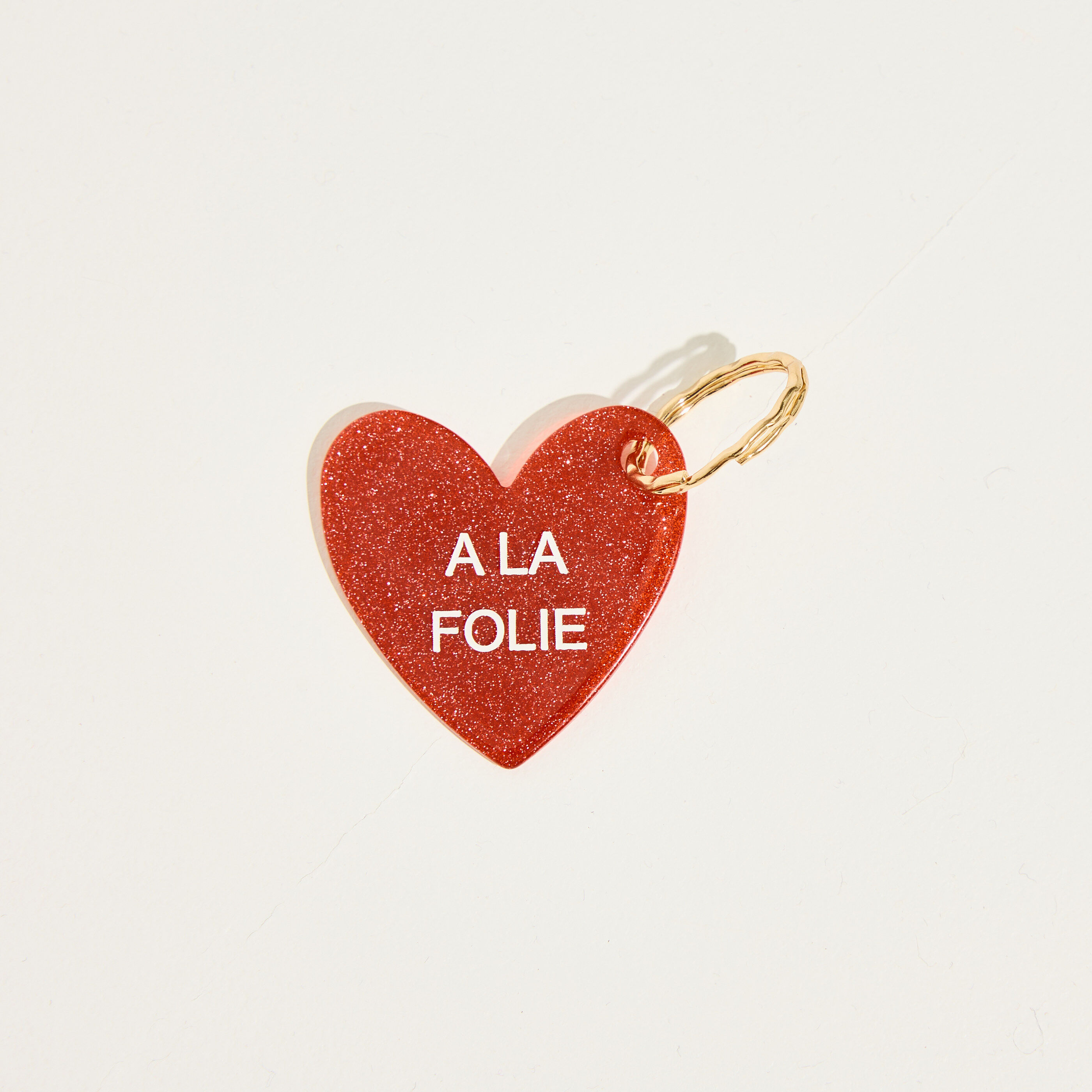 Porte-cl&eacute;s c&oelig;ur message A LA FOLIE 